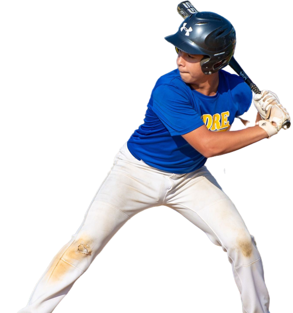 A baseball player poised to swing, wearing a blue helmet and shirt, white pants with dirt stains. Focused and ready posture against a black background.